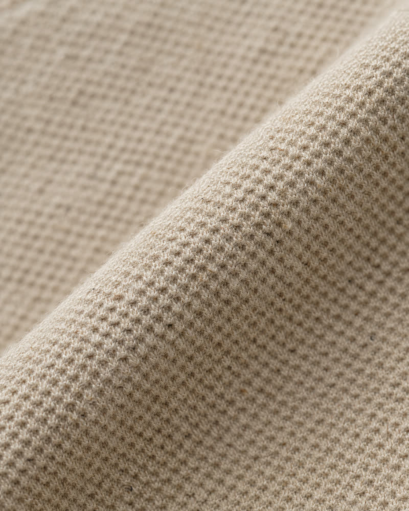 Macro of sand organic cotton piqué knit